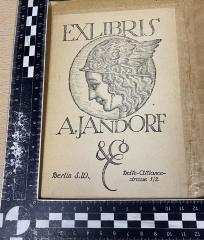 - (Jandorf, Adolf), Etikett: Exlibris; 'Exlibris A. Jandorf & Co Berlin S.W., Belle-Alliancestrasse 1/2'.  (Prototyp)